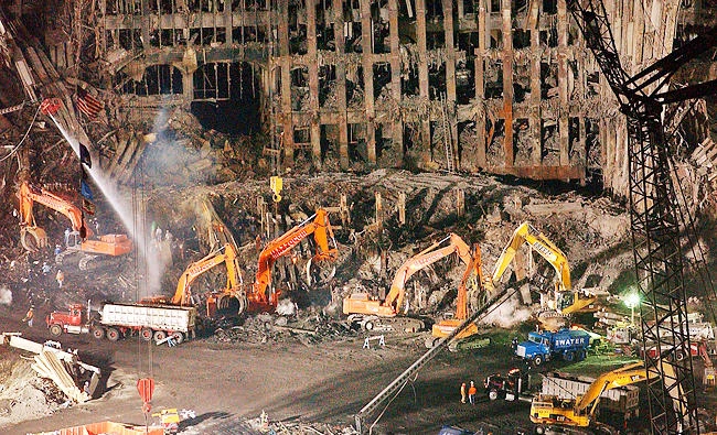 In this Nov. 7, 2001 file photo, workers and heavy machinery continue the cleanup and recovery effort in front of the remaining facade of 1 World Trade Center at ground zero in New York. (AP)