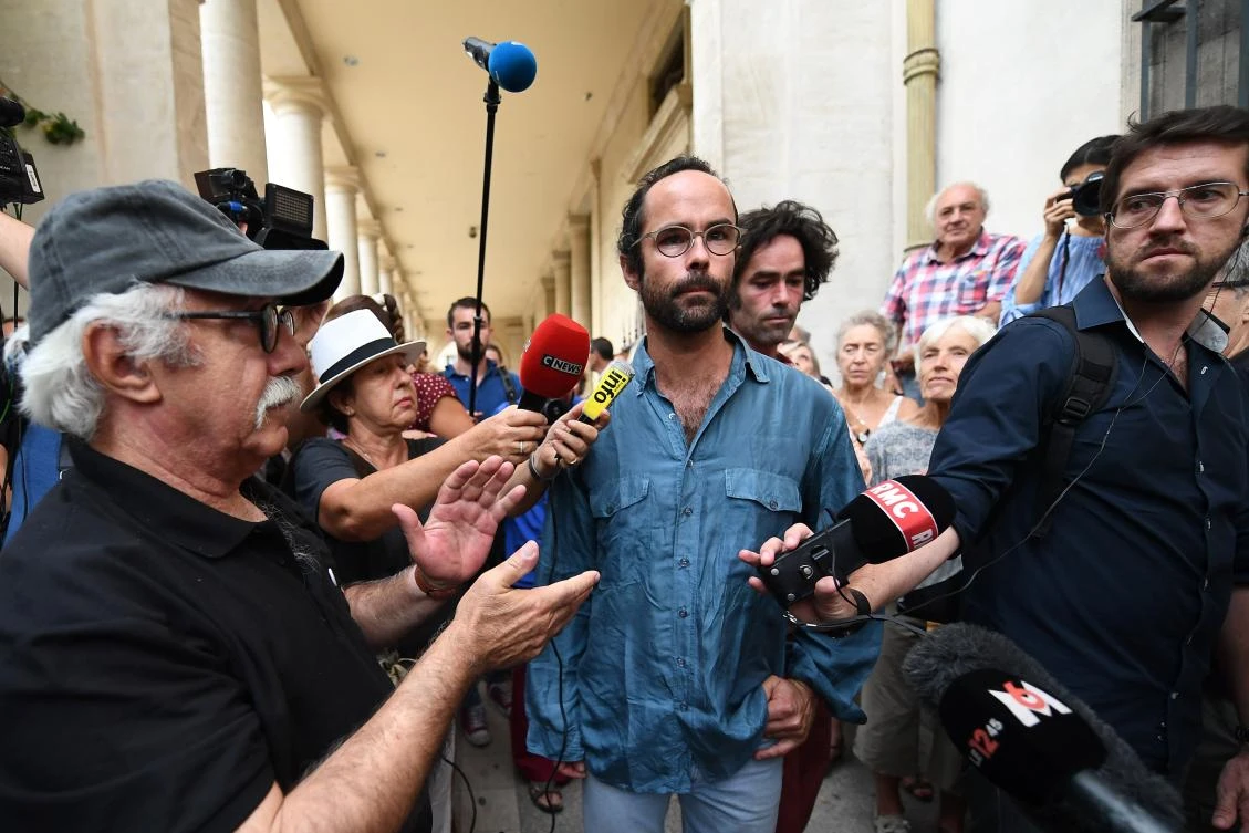 French farmer Cedric Herrou speaks to reporters outside the courthouse in Aix-en-Provence on August 8, 2017. Herrou was sentenced to a four month suspended jail sentence for illegally assisting migrants. (AFP)