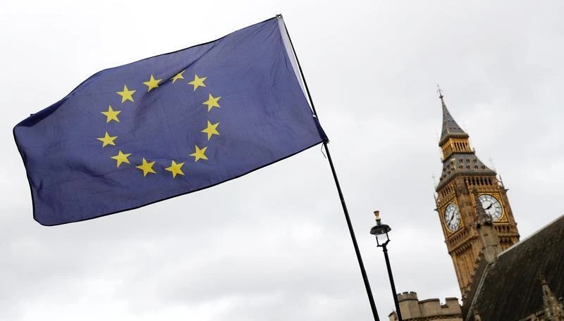 FILE PHOTO - A European Union flag is waved in front of Big Ben outside Parliament after Britain's Prime Minister Theresa May triggered the process by which the United Kingdom will leave the European Union in London, March 28, 2017. (REUTERS)