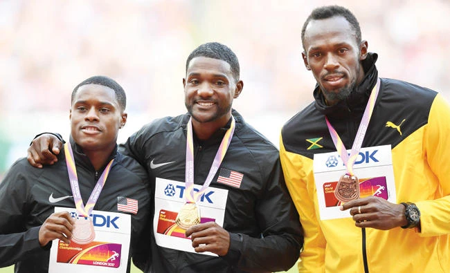 Silver medalist US athlete Christian Coleman, left, gold medalist US athlete Justin Gatlin, center, and bronze medalist Jamaica’s Usain Bolt, right, during the victory ceremony for the men's 100 meters on Sunday. (AFP)