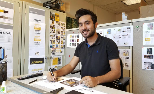 In this undated photo provided by Adelphi University, student Usman Anwar works at his campus job on Long Island, N.Y. Anwar said he skipped a trip home to Pakistan this summer because he worried he might not be allowed to re-enter the U.S. if he left. Like Anwar, some international students have remained in the U.S. because they worried about potential travel troubles, even if they aren't from majority Muslim countries in the government's travel ban rules. (AP)