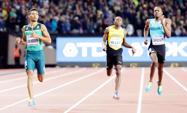 South Africa's Wayde Van Niekerk, left, races to the line to win the gold medal in the men's 400m final during the World Athletics Championships in London Tuesday. (AP)