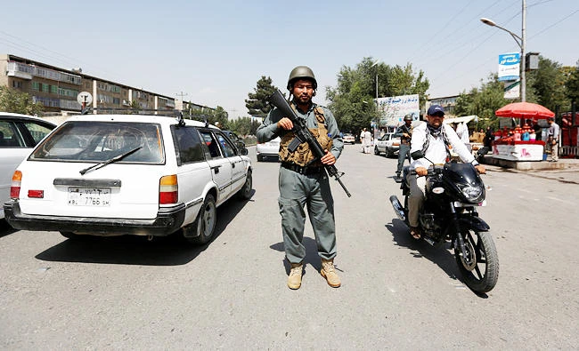 An Afghan police officer inspects vehicles at a checkpoint in Kabul, Afghanistan, in this August 6, 2017 photo. (REUTERS)
