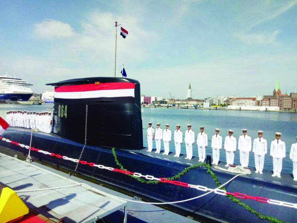 Egyptian Navy officers stand aboard the deck of S42, a German-made Type-209/1400 submarine, during a handover ceremony in the German Baltic city of Kiel. (AFP)