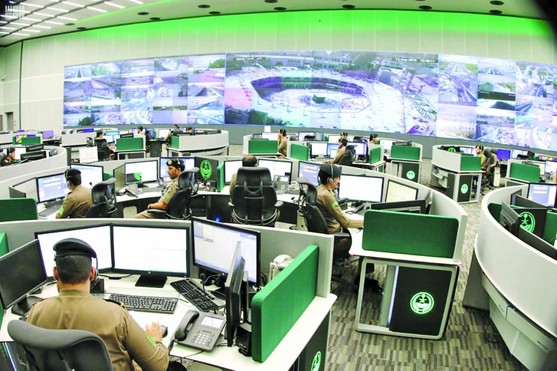 Saudi security officers monitor screens with live views of Hajj pilgrims at the Grand Mosque, along with highways and high-density areas in Makkah on Wednesday. (SPA)