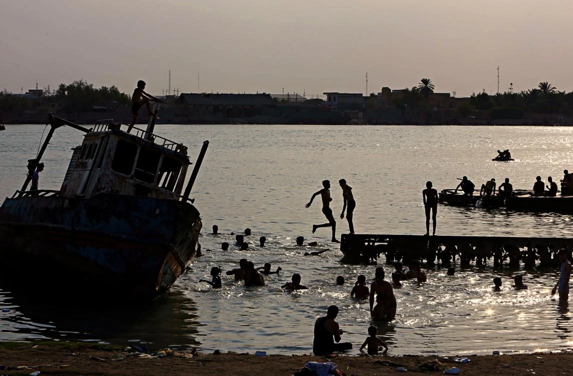 In this photo taken on Saturday, July 29, 2017, people swim in the Shatt al-Arab waterway to beat the heat, near Basra, 340 miles (550 kilometers) southeast of Baghdad, Iraq. Iraq's weather service warned Thursday, Aug. 3, 2017 that temperatures will increase next week in most parts of the country, with the highs expected to reach 51 degrees Celsius, or about 124 degrees Fahrenheit, adding to the daily woes of Iraqi citizens already facing a deteriorated security situation and lack of public services. (AP)