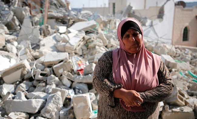 A Palestinian woman reacts after her family house was demolished by Israeli troops in the West Bank village of Deir Abu Mashal, near Ramallah, on Thursday. (AFP)