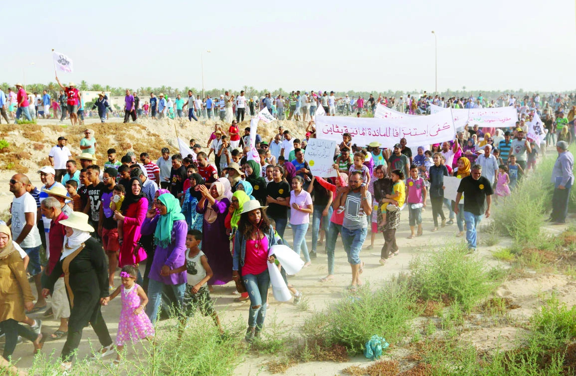 Residents protest against pollution caused by nearby factories on the road leading to the industrial zone of Ghannouch in Tunisia’s Gabes region recently. (AFP)