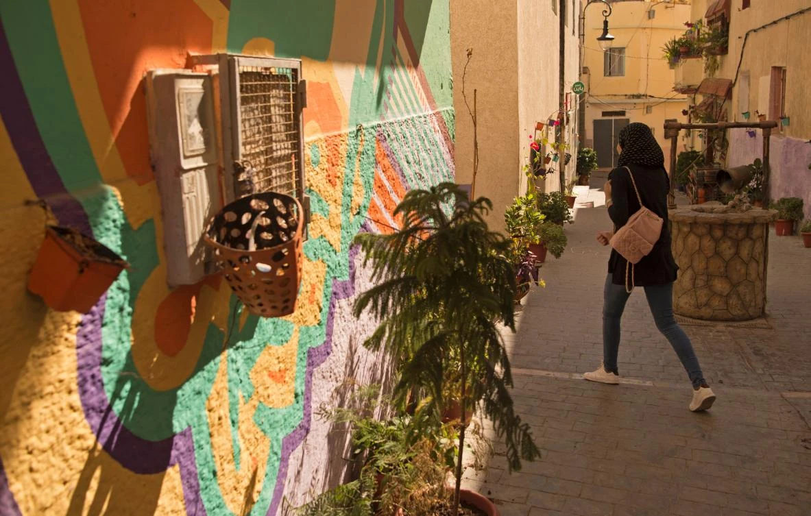 This file photo taken on September 28, 2016 shows a Moroccan woman walking down a street in the old part of the port city of Tangiers. A 10-second video shared on social media in Morocco in late July 2017 has sparked a heated debate, as it showed a group of men hounding a panicking young woman in jeans and a tank-top as she was walking alone at night in a street in Tangiers. (AFP / FADEL SENNA)