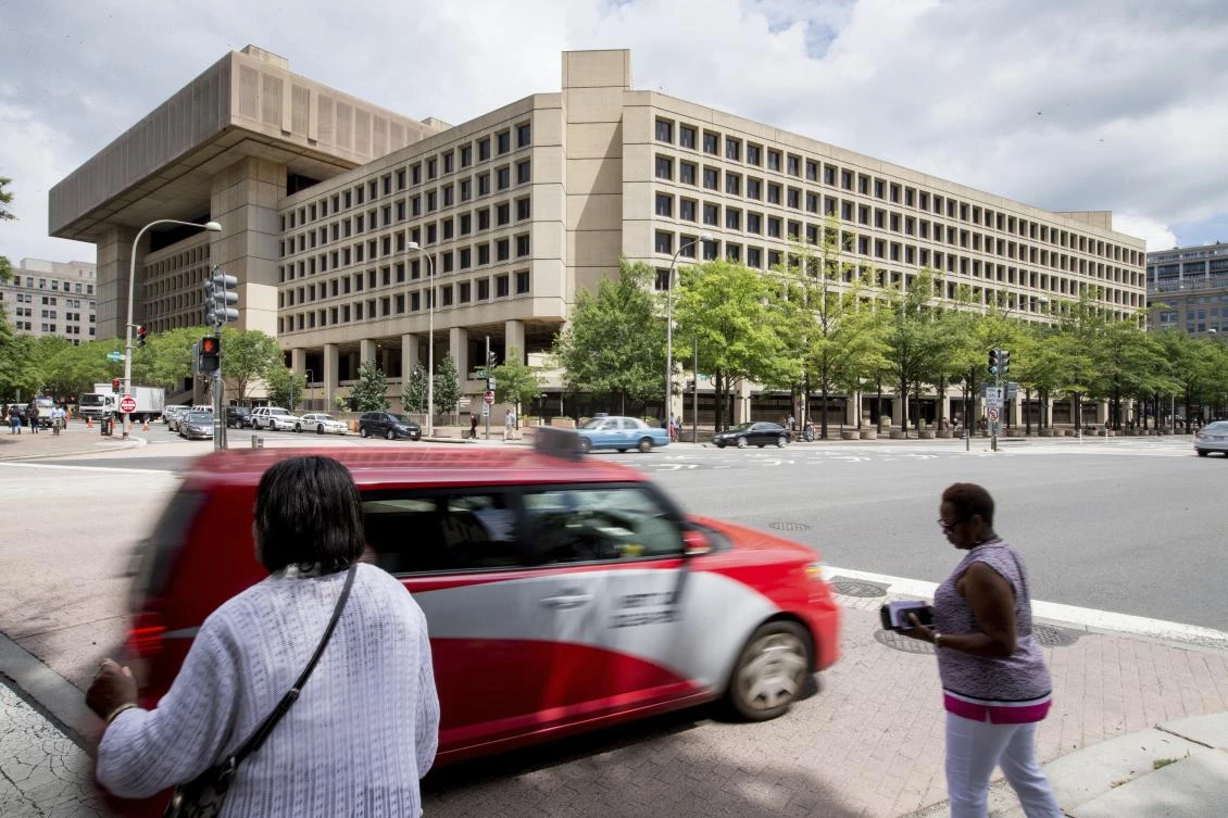 This Aug. 19, 2015 file photo, the J. Edgar Hoover Building, The Federal Bureau of Investigation headquarters, in Washington. The US has orchestrated the arrest of five alleged Russian cybercriminals across Europe in the past nine months. The operations come at a fraught moment in relations between Russia and the US, where politicians are grappling with the allegation that Kremlin hackers intervened in the 2016 election. (AP Photo/Andrew Harnik, File)