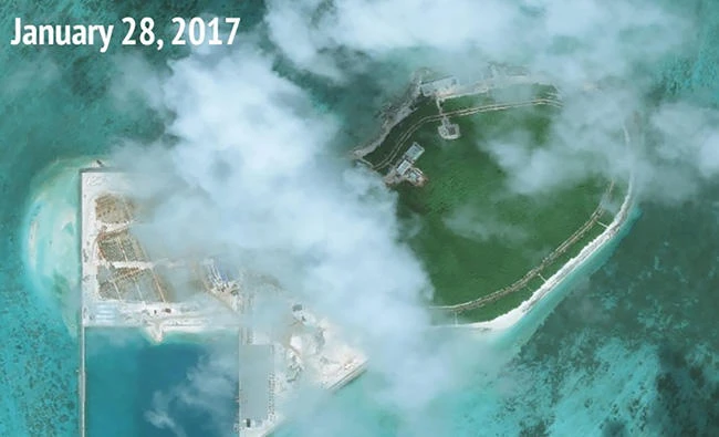 This handout photo taken on January 28, 2017 by satellite imagery provider DigitalGlobe and released to AFP on August 11, 2017 by the Asia Maritime Transparency Initiative (AMTI) department at the Center for Strategic and International Studies (CSIS) think tank shows an overview satellite image of Tree Island in the disputed Paracels island chain in the South China Sea, showing new reclamation work and structures built. (AFP / CSIS Asia Maritime Transparency Initiative)