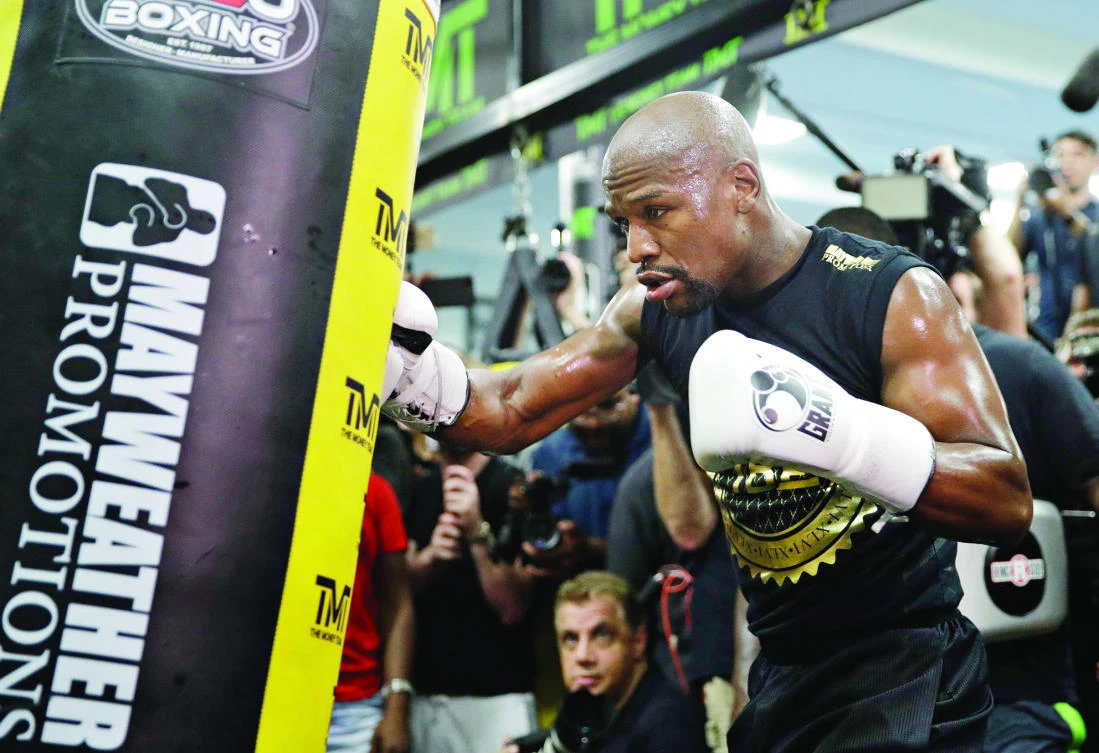 Floyd Mayweather Jr. trains at his gym while surrounded by media in Los Angeles on Thursday. (AP)