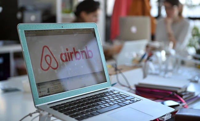 This file photo taken on April 21, 2015 shows the logo of online lodging service Airbnb displayed on a computer screen in the Airbnb offices in Paris on April 21, 2015. (AFP)