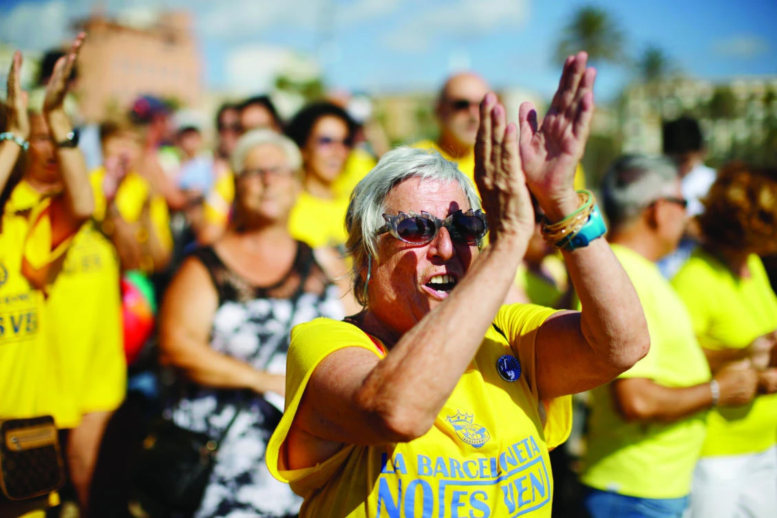 A woman applauds during a protest against tourism on Saturday in Barcelona, Spain. (AP)