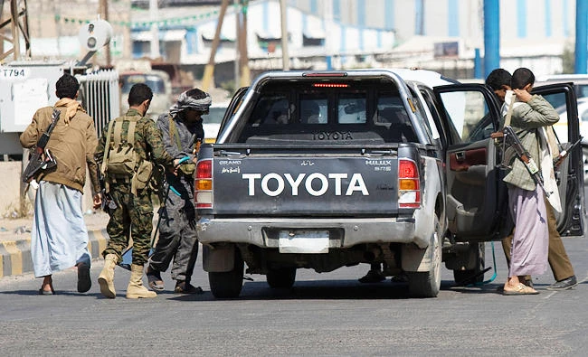 Houthis check a car as they guard a street during clashes near the presidential palace in Sanaa, Yemen, in this file photo. (AP)