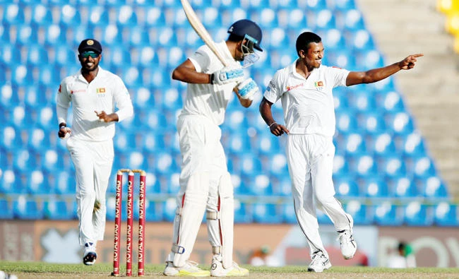 Lanka’s Vishwa Fernando celebrates after taking the wicket of Ravichandran Ashwin during a Test match between Sri Lanka and India in Pallekele, Sri Lanka, on Saturday. (Reuters)