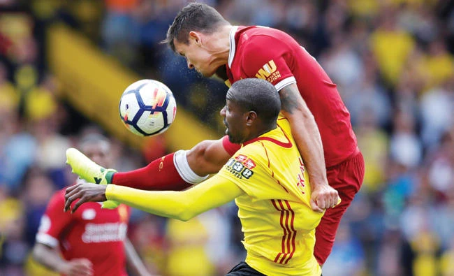 Dejan Lovren and Stefano Okaka in action during a match between Watford and Liverpool in Watford, England, on Saturday. (Reuters)