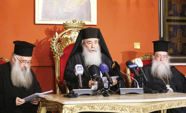Greek Orthodox Patriarch of Jerusalem Theophilos III, center, speaks during a press conference in Amman on Saturday. (AFP)