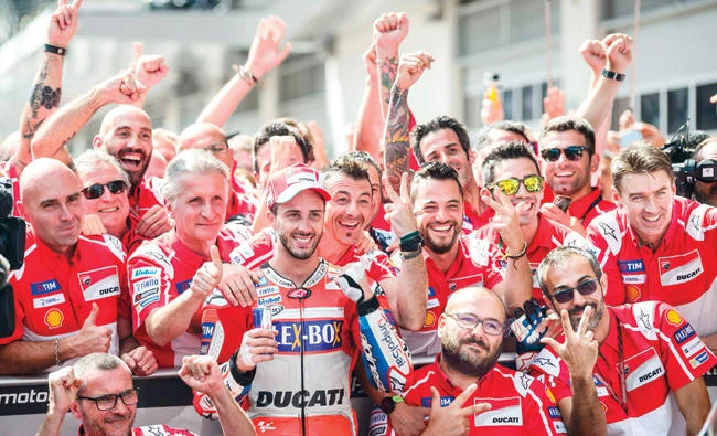 Ducati Team's Italian rider Andrea Dovizioso, center, and his team celebrate after winning the MotoGP Austrian Grand Prix race at Red Bull Ring in Spielberg, Austri, on Sunday. (AFP)