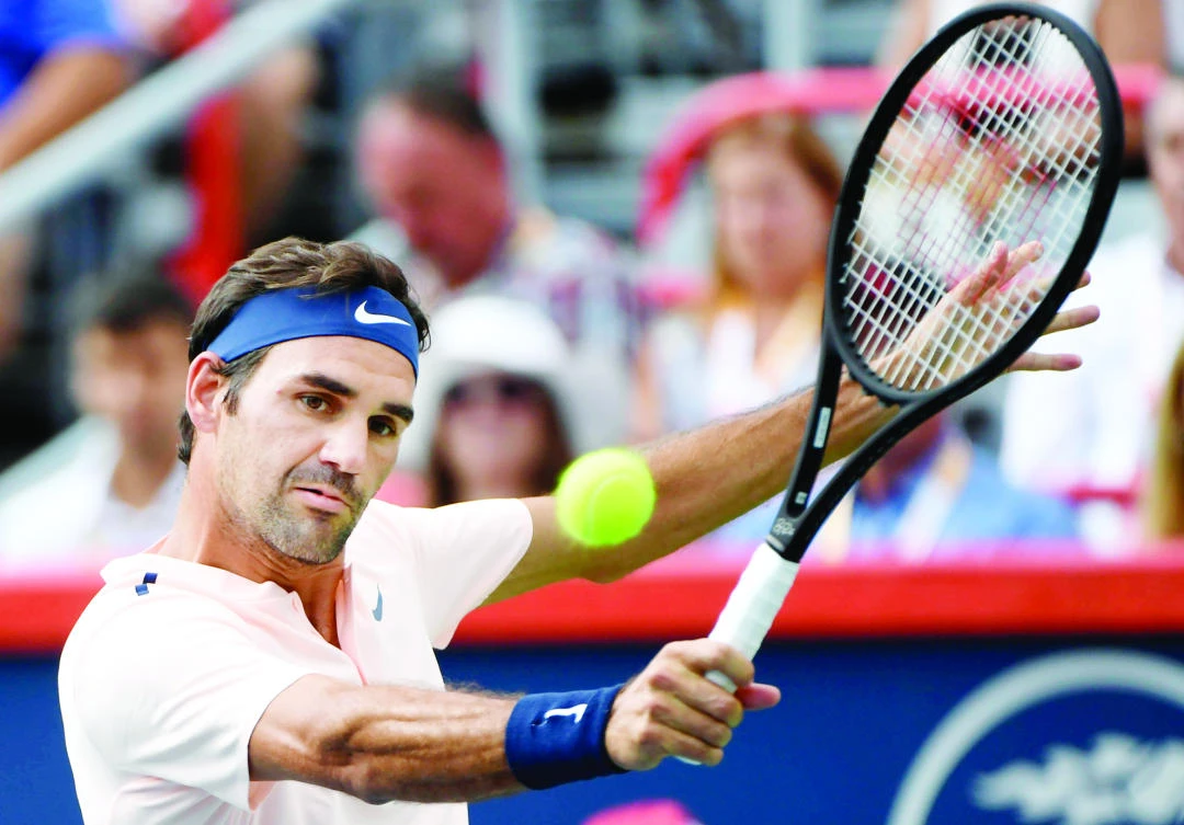 Roger Federer of Switzerland hits a backhand against Robin Haase of the Netherlands (not pictured) during the Rogers Cup tennis tournament at Uniprix Stadium Saturday. (USA TODAY Sports)