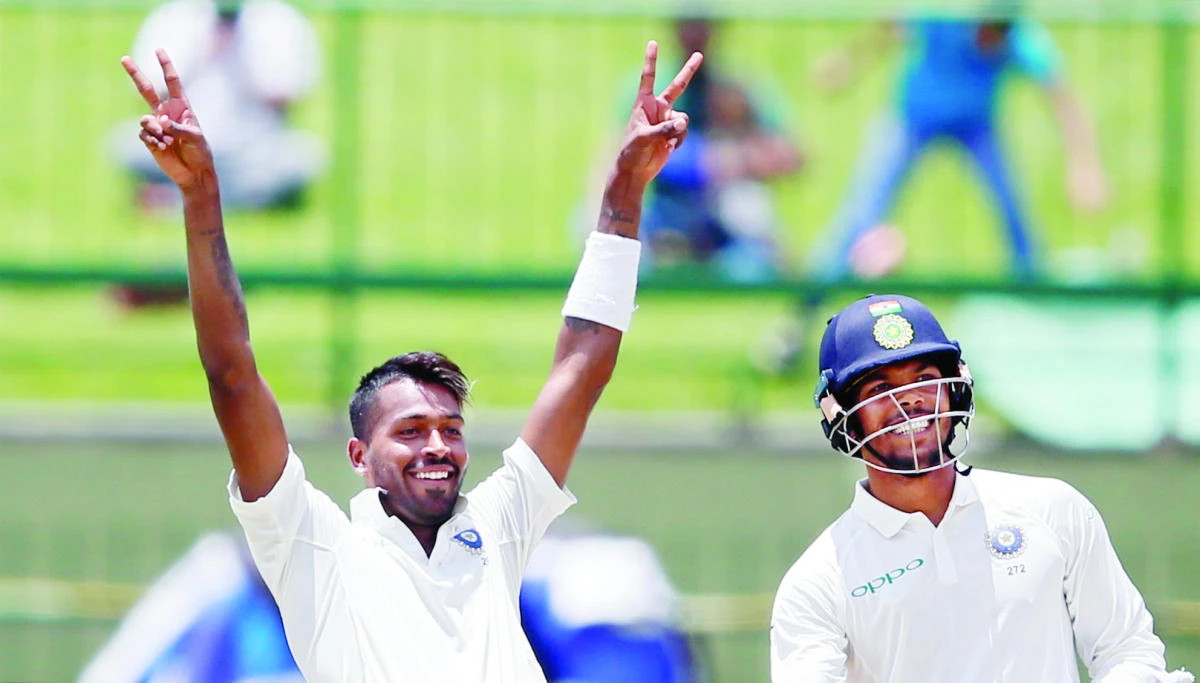India's Hardik Pandya celebrates his century next to his teammate Umesh Yadav. (Reuters)
