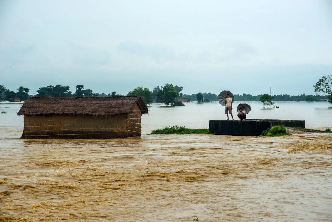 Nepali residents look at the water in a flooded area in the Birgunj Parsa district, some 200 km south of Katmandu, on Monday. (AFP / Manish Paudel)