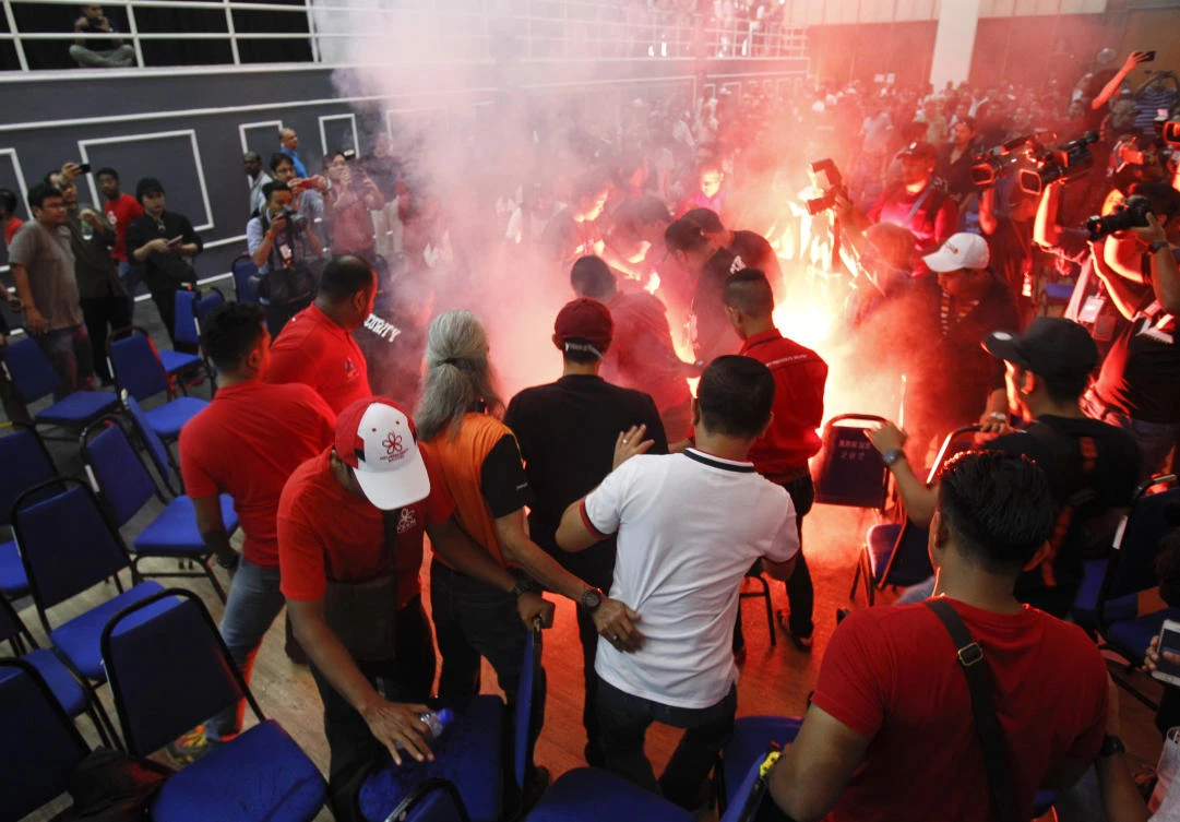 Flares hurled by people rise during a forum of former Malaysian Prime Minister Mahathir Mohamad in Shah Alam, Malaysia, Sunday, Aug. 13, 2017. Mahathir who now heads an opposition coalition, was marred by violence, with several people hurling flares, chairs and shoes at the stage. Mahathir, who has set up a new political party to oust Prime Minister Najib Razak in elections due by mid-2018, was answering questions at the forum, hosted by his party, when chaos erupted. (AP)