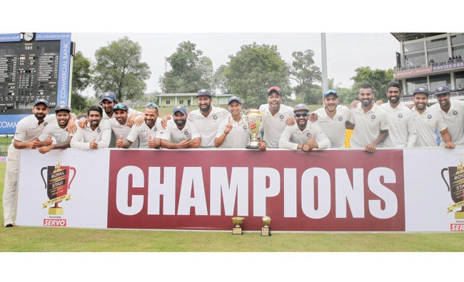 Members of Indian cricket team pose with the winners trophy after their victory over Sri Lanka in the third cricket Test match in Pallekele, Sri Lanka, Monday. (AP)