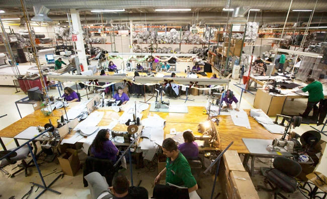 In this Dec. 27, 2013 file photo, workers manufacture car dash mats at a maquiladora belonging to the TECMA group in Ciudad Juarez, Mexico. (AP)