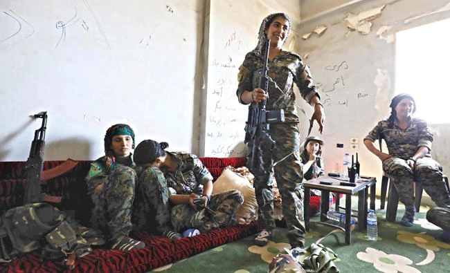 Members of the Women’s Protection Units rest in an abandoned building in Raqqa during the offensive to retake the city from Daesh. (AFP)