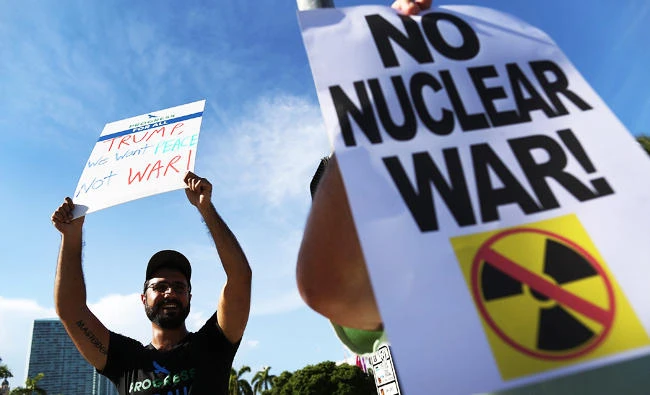 Farbod Tehranian joins other protesters gathered to ask President Donald Trump to stop his drive to war against North Korea on Tuesday in Miami, Florida. (AFP)