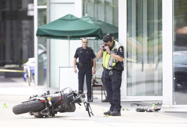 A police officer photographs a motorcycle after a female stunt driver working on the movie “Deadpool 2” died after a crash on set, in Vancouver. (AP)