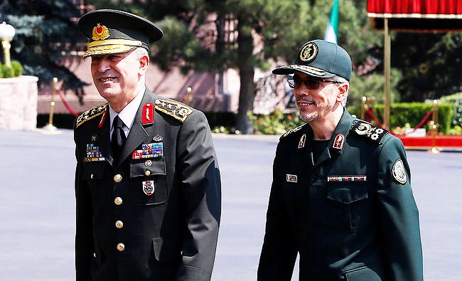 Turkish Chief of Staff General Hulusi Akar and his Iranian counterpart Major General Mohammad Baqeri are seen during a welcoming ceremony in Ankara, Turkey, on Tuesday. (REUTERS)