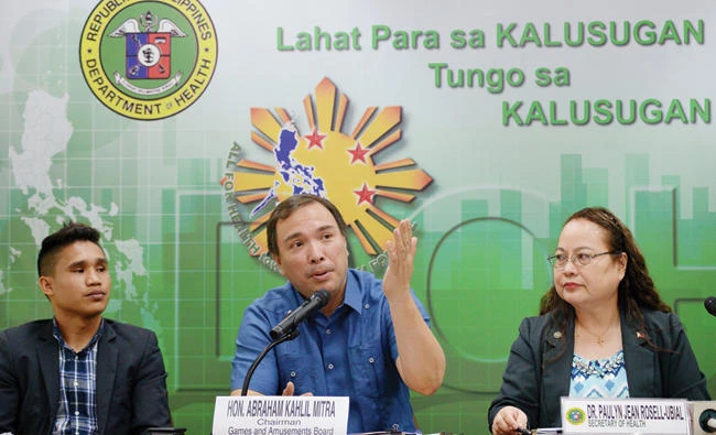 Games and Amusement Board (GAB) Chairman Abraham Kahlil Mitra, center, speaks while Philippine Health Secretary Paulyn Ubial, right, and boxer Renie Dacquel listen during a press conference about boxing, in Manila on Tuesday. (AFP)