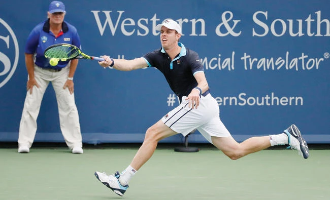 Sam Querrey returns to Stefan Kozlov during the first round at the Western & Southern Open tennis tournament Monday in Mason, Ohio. (AP)