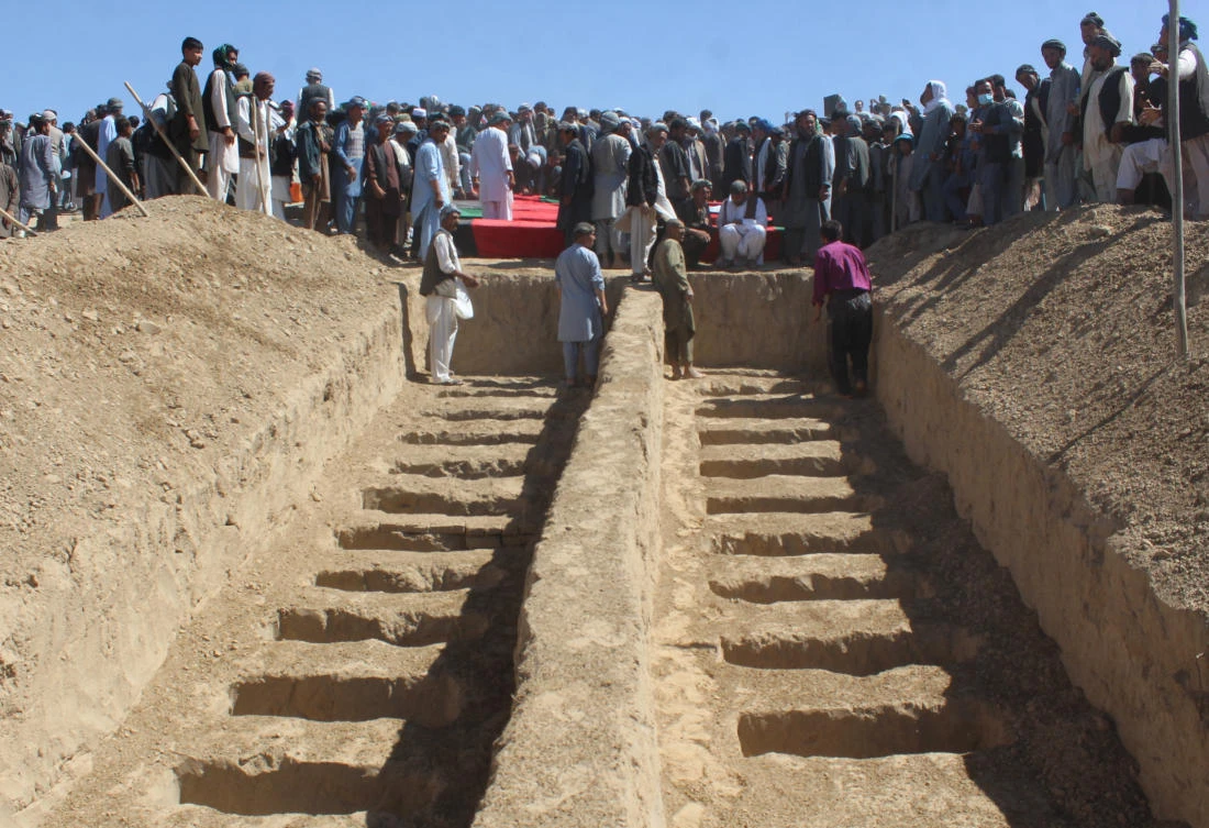 Afghan police discover mass graves after village attack