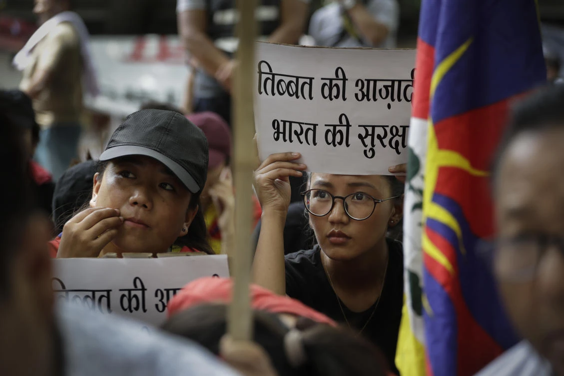 Exile Tibetans listen to a speaker during a protest to show support with India Doklam standoff in New Delhi, India, Friday, Aug. 11, 2017. Tensions between Indian and China flared last month in the southernmost part of Tibet, in an area also claimed by Indian ally Bhutan, after Chinese teams began building a road onto the Doklam Plateau. The banners in local language read Tibet's independence is India's security. (AP)
