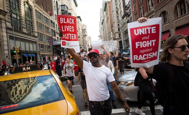 Protestors make their way north on Fifth Avenue as they march against white supremacy and racism, August 13, 2017 in New York City. 32-year-old Heather Heyer was killed in Charlottesville on Saturday when a car driven by a white supremacist barreled into a crowd of counter-protesters following violence at the Unite the Right rally. (AFP)