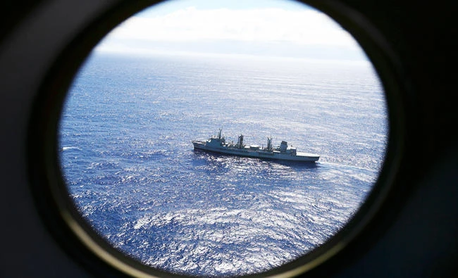 In this March 31, 2014 file photo, HMAS Success scans the southern Indian Ocean, near the coast of Western Australia, as a Royal New Zealand Air Force P3 Orion flies over, while searching for missing Malaysia Airlines Flight MH370. (AP)