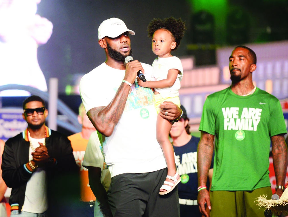 Cleveland Cavaliers' LeBron James speaks while holding his daughter, Zhuri, during the We Are Family Reunion at Cedar Point in Sandusky, Ohio, Tuesday. (AP)