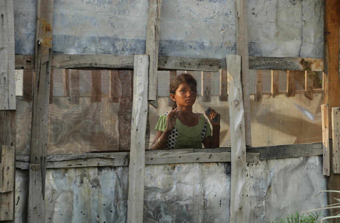 A Rohingya refugee girl looks through a mesh window at a camp set up for the refugees on the outskirts of Jammu, India, Wednesday, Aug. 16, 2017. A day after the U.N. chief voiced concern about Indian plans to potentially deport tens of thousands of Muslim Rohingya refugees, an Indian government official said Wednesday that authorities are only working to identify those who fled persecution in neighboring Myanmar, not expel them. An estimated 40,000 Rohingya Muslims have taken refuge in various parts of India, though fewer than 15,000 are registered with the U.N. High Commissioner for Refugees. (AP)