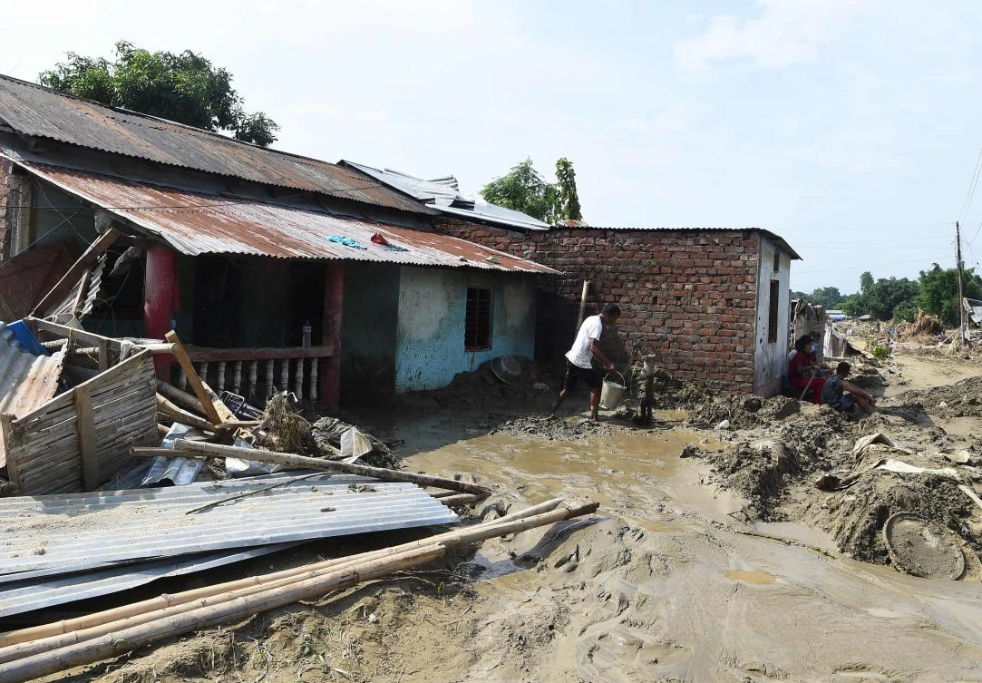 This file photo shows a man collects water from a pump in front of his house damaged by flood in Katmandu, on August 16, 2017. (AFP)