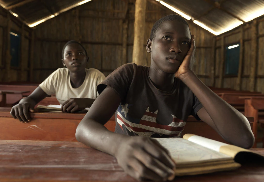 In this photo taken Saturday, July 29, 2017, Tabu Sunday, 14, right, a South Sudanese refugee symbolically named by UNHCR as the one millionth to have arrived in Uganda, sits with her twin sister Rena in a classroom at the Imvepi settlement in northern Uganda. The number of South Sudanese refugees sheltering in Uganda has reached 1 million, the United Nations said Thursday, Aug. 17, 2017, a grim milestone in what has become the world’s fastest-growing refugee crisis. (UNHCR via AP)