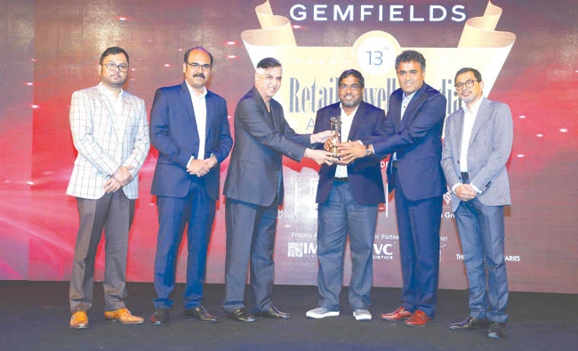M.P. Ahammed, Malabar Group chairman, receives Gemfield’s Retail Jeweller India Award from Praveen Shanker Pandai, Gem and Jewellery Export Council president, and Gyan Shyam Dholakia, Harikrishna Exports Pvt. Ltd. managing director.