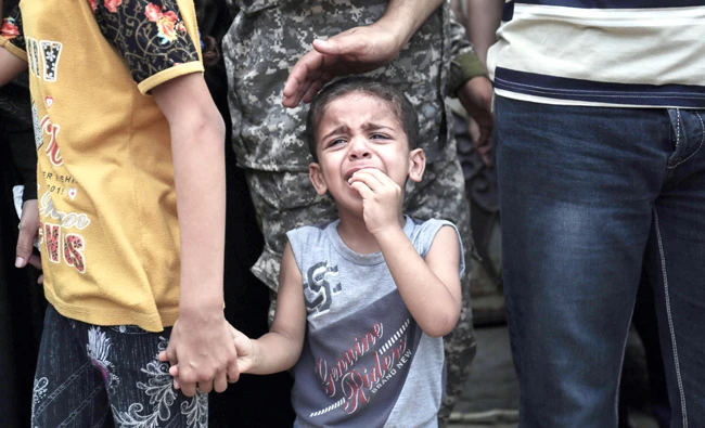 A child cries during the funeral of Nidal Al-Jaafari, a 28-year-old Hamas commander, who was killed in a suicide attack near the Gaza Strip’s crossing with Egypt. (AFP)