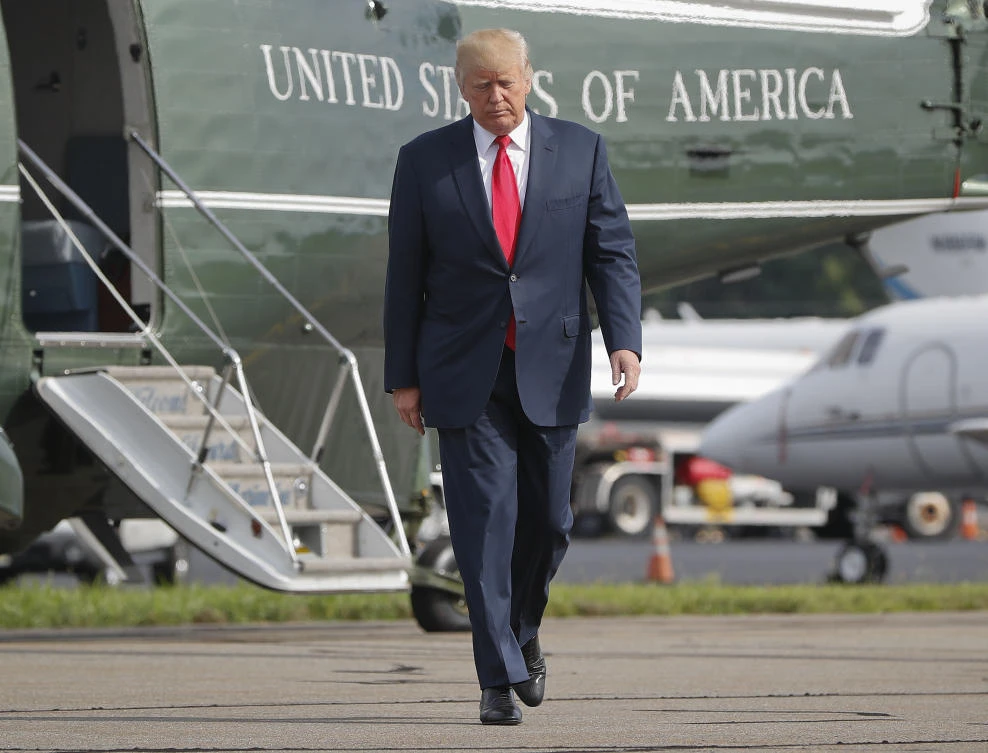 In this Aug. 14, 2017 file photo, President Donald Trump walks across the tarmac from Marine One to board Air Force One at Morristown Municipal Airport in Morristown, N.J. Bombarded by the sharpest attacks yet from fellow Republicans, President Donald Trump on Thursday, Aug. 17, 2017, dug into his defense of racist groups by attacking members of own party and renouncing the rising movement to pull down monuments to Confederate icons. (AP)