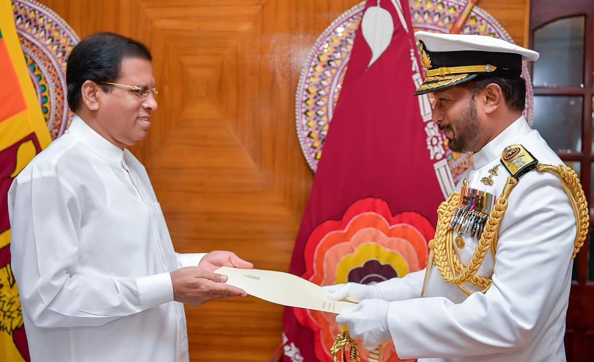 In this handout photograph taken and released by the Sri Lankan President's Office on August 18, 2017, Sri Lankan President Maithripala Sirisena (L) swears in the new Navy commander Rear Admiral Travis Sinniah (R) in Colombo. Sri Lanka's President Maithripala Sirisena on August 18 appointed an officer from the island's Tamil minority to head the navy for the first time since a separatist war erupted 45 years ago. Rear Admiral Travis Sinniah is the first Tamil to head a wing of the military since 1970, even though Tamils make up around 15 percent of Sri Lanka's population. (AFP)