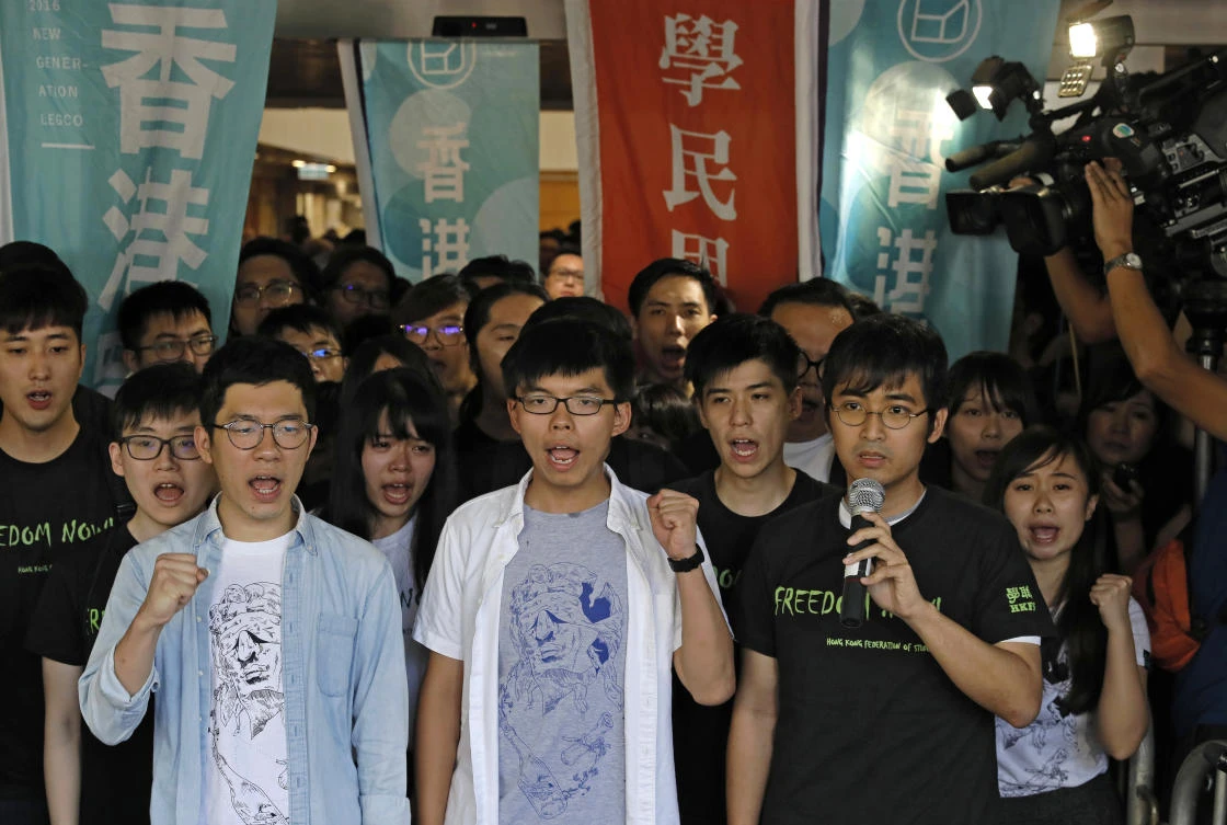 Hong Kong activists, from left to right, Nathan Law, Joshua Wong and Alex Chow chant slogans outside the high court before a ruling on a prosecution request for stiffer sentences in Hong Kong, Thursday, Aug. 17, 2017. Young Hong Kong activist Wong and two other student leaders of huge pro-democracy protests in 2014 braced for a court decision Thursday that could send them to prison. The three were found guilty of leading or encouraging an illegal rally in September 2014 that kicked off the demonstrations known as the "Umbrella Movement." (AP)