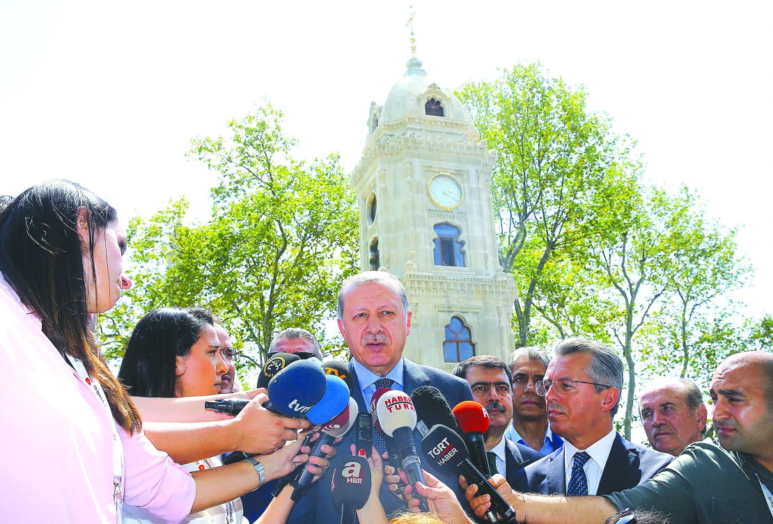 Turkey’s President Recep Tayyip Erdogan talks to journalists after attending Friday prayers in Istanbul. (AP)