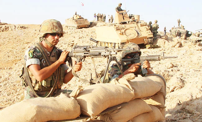 A photo taken on August 17, 2017, during a tour guided by the Lebanese army, shows soldiers holding a position in a mountainous area near the eastern town of Ras Baalbek during an operation against jihadist fighters. (AFP)